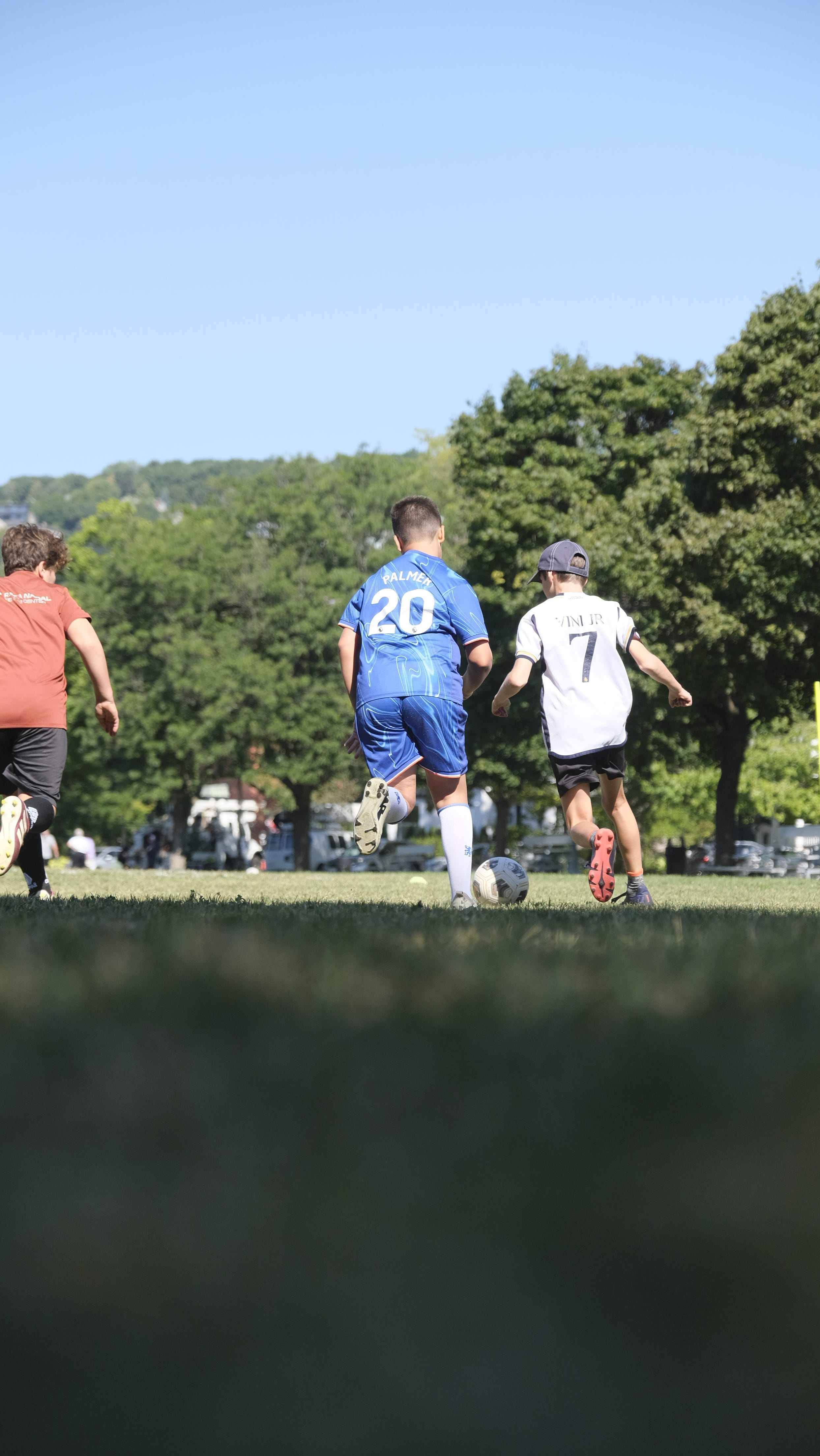 Young players waiting their turn during a large-group soccer session